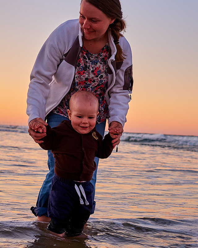 Derrick's Wife walking his son on a beautiful beach