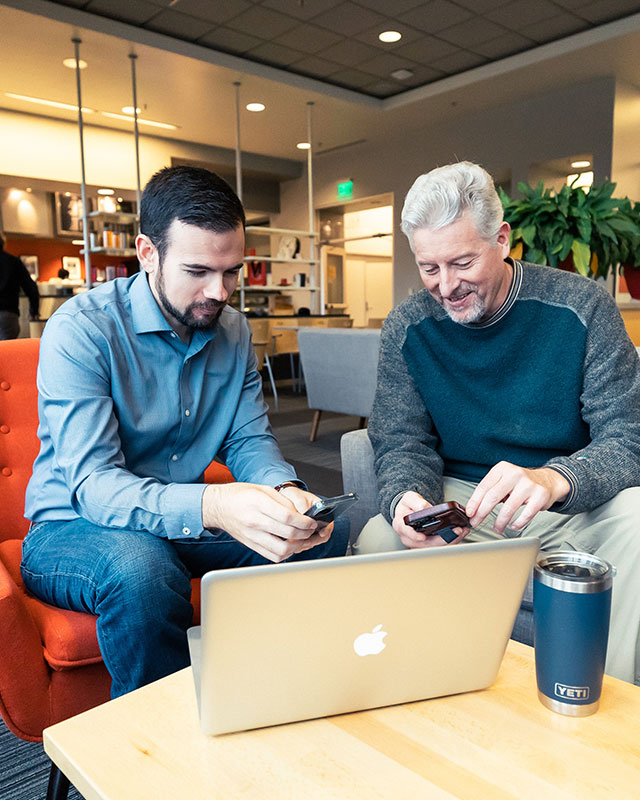 Derrick and joe law comparing looking at mobile phone